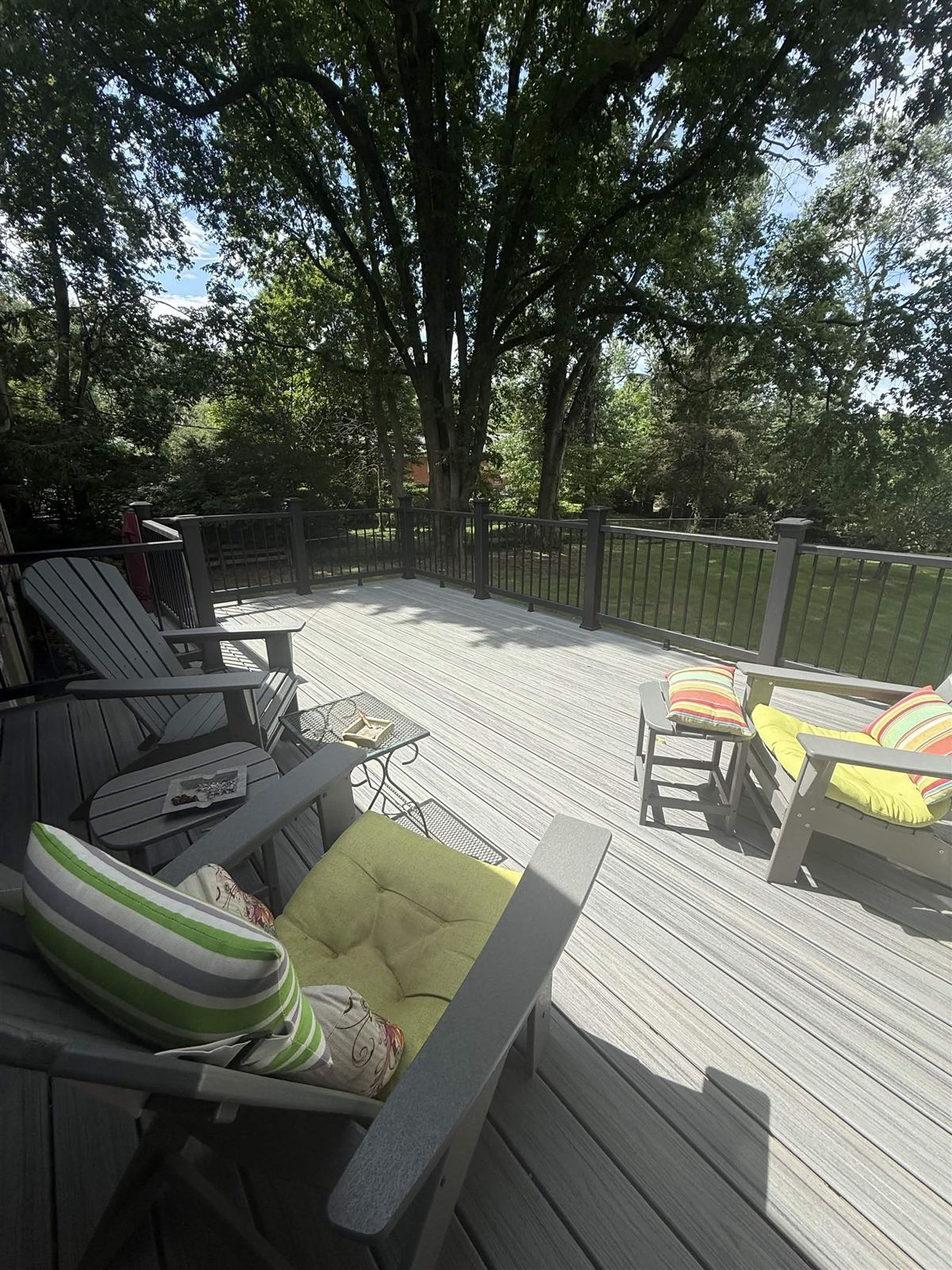 Spacious composite deck with outdoor furniture and dark railing by Big Blue Fence & Deck in Lexington KY